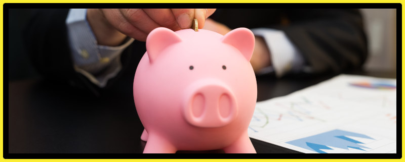 Businessman placing coin in a piggy bank saving funds. 